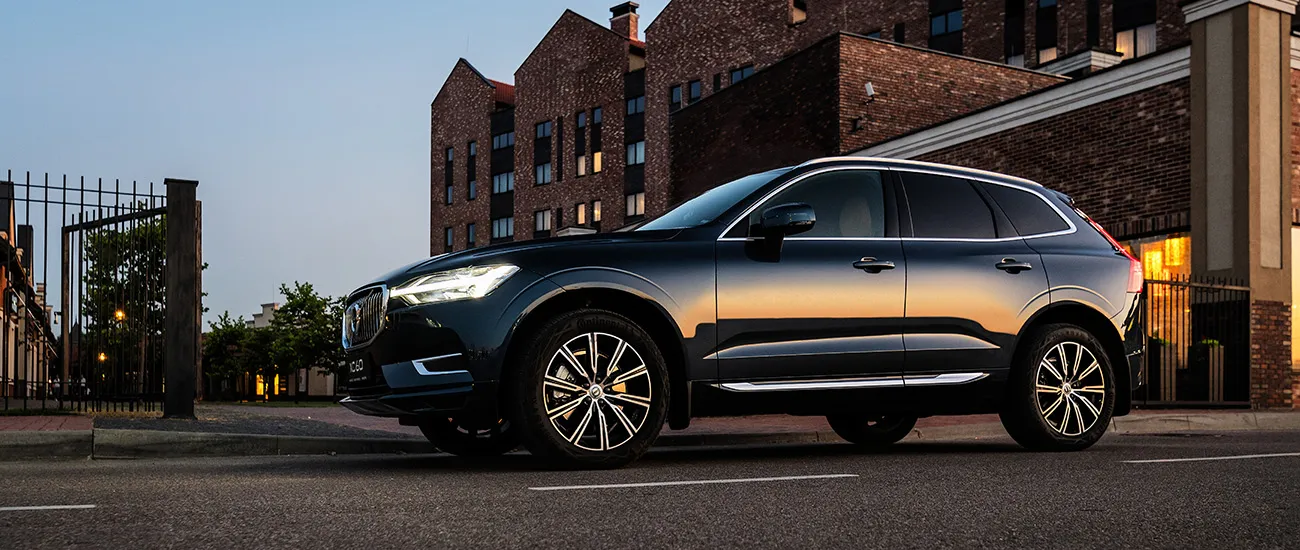 Finesse | an image of a Volvo parked next to a building with sunrays reflecting