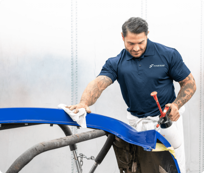 Finesse | Image of one of our members of staff working on a vehicle chasis